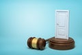 3d rendering of white doorway on round wooden block and brown wooden gavel on blue background Royalty Free Stock Photo