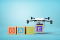 3d rendering of white drone carrying alphabet toy blocks making `GAME` sign on blue background