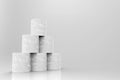 3d rendering. White tissue paper rolls stack on gray background.