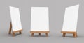 3D rendering of wooden easels with empty canvas isolated on a gray background