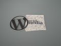 3d rendering of the Wordpress Logo and social media on the paper against a grey background