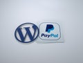 3d rendering of the WordPress and PayPal logos against a grey background