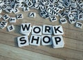 Work shop written in letter tiles wooden background