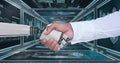 3D robot hand and person shaking hands against background with medical interfaces Royalty Free Stock Photo