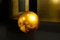 3d sphere on black table background texture with shadow. Crystal shape or realistic glass ball in gold metal. 3D render modern Royalty Free Stock Photo