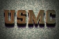 3D text of a Military Service, USMC, on a digital camo background