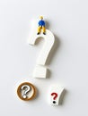 A 3D Toy Of A White People Lying On A Question Mark On A Bright White Background. Generative AI Royalty Free Stock Photo