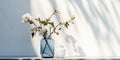 3D Transparent blue glass vase with white rose flower bouquet of green tree twig in outdoor sunlight on concrete counter and wall Royalty Free Stock Photo