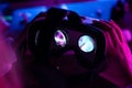 3d 360 vr headset glasses in female hands futuristic purple neon light