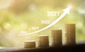 Growth in 2021 year concept. Business graph with arrow up. Growing money coins stack Royalty Free Stock Photo