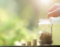 Hand drop money coins to jar. Royalty Free Stock Photo