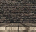 3D wooden table against defocussed brick wall Royalty Free Stock Photo