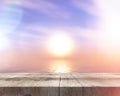 3D wooden table looking out ot a sunset ocean landscape Royalty Free Stock Photo