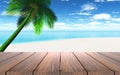 3D wooden table looking out to a beach with palm tree Royalty Free Stock Photo