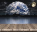 3D wooden table looking out to a defocussed night scene Royalty Free Stock Photo