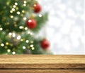 3D wooden tale looking out to a defocussed Christmas tree Royalty Free Stock Photo