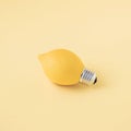 3D yellow lemon light bulb on pastel blue background - summer concept