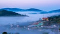 Da lat, lam dong, viet nam- feb 12, 2017: beautyful landscape of da lat city, a small vietnamese pagoda in fog and the pine hill Royalty Free Stock Photo