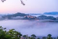 Da lat, lam dong, viet nam- feb 12, 2017: beautyful landscape of da lat city, a small vietnamese pagoda in fog and the pine hill Royalty Free Stock Photo