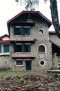 French architecture of ancient stone house with green wooden window and door at Da Lat Royalty Free Stock Photo