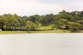 A view of the green golf course across the Ho Xuan Huong lake in the hill town of Dalat Royalty Free Stock Photo