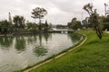 A view of the green golf course across the Ho Xuan Huong lake in the hill town of Dalat Royalty Free Stock Photo