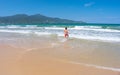 Da Nang Beach: an excited man runs through the surf to the gentle sea waves on My Khe Beach Royalty Free Stock Photo