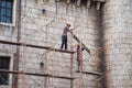 Da Nang, Vietnam - Apr 2, 2016: Workers with no protection belt fixed on scaffold at construction site in Hoa Vang district, Da Na Royalty Free Stock Photo