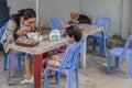 Mother and child having breakfast on blue chairs, Da Nang Vietnam Royalty Free Stock Photo