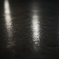 DaAIgeneratedrk surface with a reflective texture, likely wet or polished, displaying light reflections. Description* Suggested by Royalty Free Stock Photo