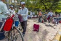 The Dabbawalas or lunch carriers wait outside the train station in Mumbai to collect lunch boxes