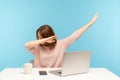 Dabbing trends. Overjoyed woman showing dab dance gesture, performing internet meme of success, sitting at workplace