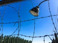 Dachau concentration camp barbed wire fence with old style outdoor lamp Royalty Free Stock Photo
