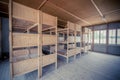 Dachau, Germany - July 30, 2015: Inside sleeping quarters with wooden bunk beds showing prisoners terrible living conditions Royalty Free Stock Photo