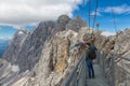 Austrian Dachstein Mountains with hikers passing a steel rope bridge Royalty Free Stock Photo