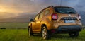 Dacia Duster SUV in the mountain wilderness during the evening downpour
