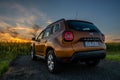 Dacia Duster SUV set against a field of blooming sunflowers