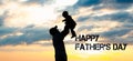 Dad and baby child silhouettes on background of sky and sun. Royalty Free Stock Photo