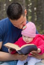 Dad and Baby Daughter Reading Bible