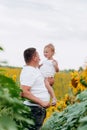 Dad with baby girl outdoors in sunflower field, love. Bonding, family, new life. Warm summer day. family concept Royalty Free Stock Photo