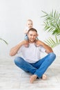 Dad with baby son around his neck having fun on a white background, happy fatherhood and family, father`s day Royalty Free Stock Photo