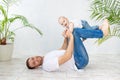 Dad and baby son play sports or have fun playing on a white background, happy fatherhood and family, father`s day