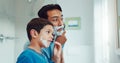 Dad, boy and learning to shave in bathroom with facial cream, skincare routine and support. Father, kid and teaching