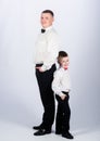 Dad and boy white shirts with bow ties. Gentleman upbringing. Little son following fathers example of noble man Royalty Free Stock Photo