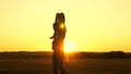 Dad carries on shoulders of his beloved child, in rays of sun. Father walks with his daughter on his shoulders in rays Royalty Free Stock Photo