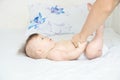 Dad changing diaper on baby girl on bed, changing nappy, everyday life Royalty Free Stock Photo