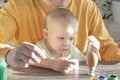 Dad and child are coloring eggs for the Easter holiday.