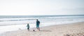 Dad and child playing outdoor. Happy sporty family concept. Father and son play soccer or football on the beach. Royalty Free Stock Photo