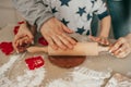 Dad and child together with hands using rolling pin roll out dough on table at home, cozy kitchen, happy hours together, teamwork