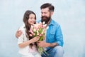 Dad congratulate small girl on holiday and give flowers. family day. spending time together. daughter take tulip flower Royalty Free Stock Photo